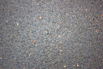 Wet asphalt with the addition of stones. Road after the rain. Texture, background.