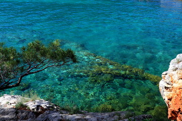 Beach, sea coast, beautiful rocks, mountains and clear blue water. Summer vacation, tourism, travel in Herceg Novi, Montenegro, Adriatic Sea