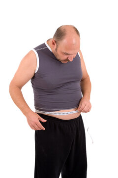 mature man with measuring tape looking shocked at his waistline