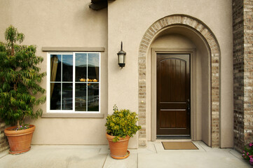 A newly constructed, modern american home doorway and patio. - obrazy, fototapety, plakaty