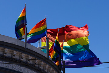 Sun shining on Rainbow Flags blowing in the wind. Harvey Milk Plaza, San Francisco. 