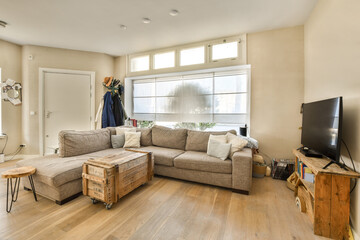 a living room with couches, coffee table, and television on the wall in the room is very clean