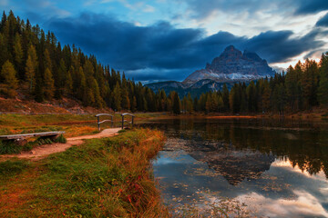 Tre Cime in the Dolomites shot from Antorno Lake at sunrise with reflection in the lake