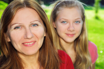 Fototapeta premium Portrait of smiling family of mother and her teenage daughter