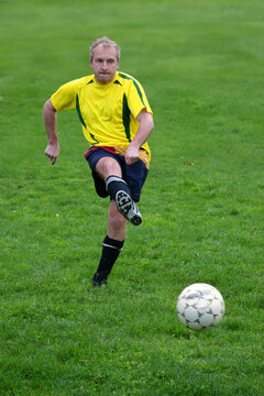 Soccer player hitting a ball