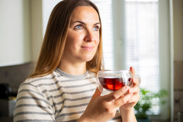 Woman holding a cup of hot tea in the morning