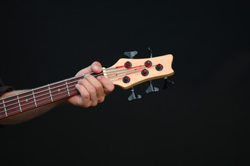 A man is playing his guitar. Taken on a black background.