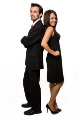 Full body of an attractive brunette business woman and man standing back to back over white