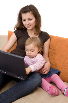 happy family sitting on sofa with laptop