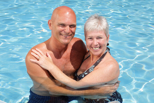 attractive couple in the swimming pool enjoying holidays together