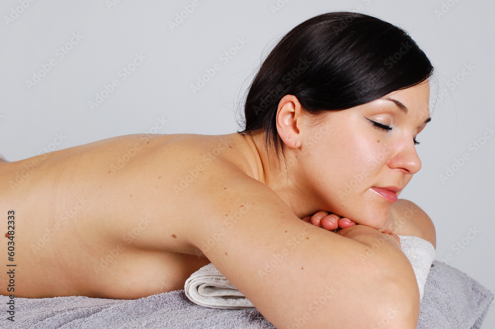 Wall mural attractive brunette woman relaxing in spa salon