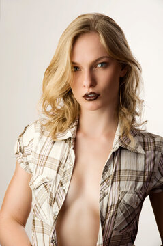 sensual portrait of pretty young blond girl with open shirt and dark lips