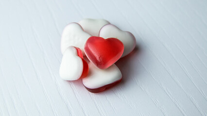 Heart shaped gummies on white background