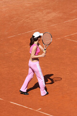 Girl playing tennis outdoor on court