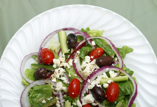 A delicious greek salad on a table.