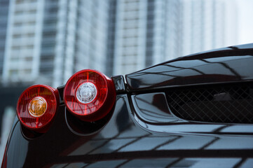 photo of sports car detail with building as a background