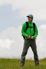 Young man on move, on the top of a mountain