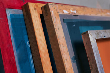 silk screen mesh screen frames close-up. silkscreen printing. serigraphy production. printing images on tshirts in a design studio