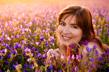 Beautiful young woman portrait on a flowery meadow