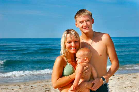 young happy family on beach