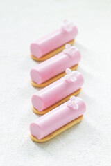 Vegan Pink tea matcha cream dessert bar decorated with a small flower. On cookie. Creamy dessert with the addition of pink pitaya powder. White background