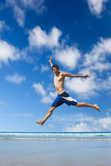 Picture of a young man jumping on the beach