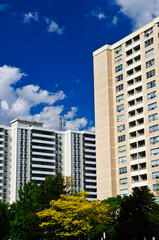Obraz premium Tall residential apartment buildings with blue sky