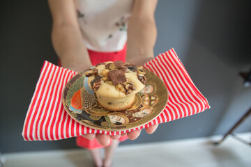 Mujer mostrando un plato con un muffin delicioso