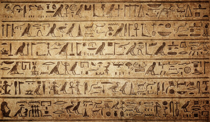 Old Egyptian hieroglyphs on an ancient background. Wide historical background. Ancient Egyptian hieroglyphs as a symbol of the history of the Earth.