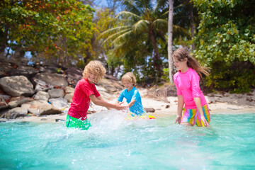 Fototapeta na wymiar Kids playing on tropical beach. Summer fun.