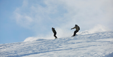 freestyle snowboarder jump and ride free style  at sunny winter day on mountain
