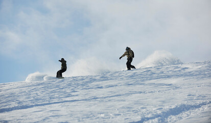 freestyle snowboarder jump and ride free style  at sunny winter day on mountain