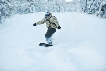 freestyle snowboarder jump and ride free style  at sunny winter day on mountain