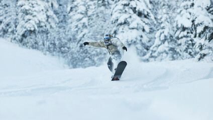 freestyle snowboarder jump and ride free style  at sunny winter day on mountain