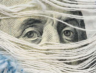 Fragment of one hundred dollar bill with a portrait of Benjamin Franklin, eye