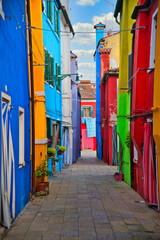 Fototapeta na wymiar Vertical shot of Colorful houses of alley in Burano island.