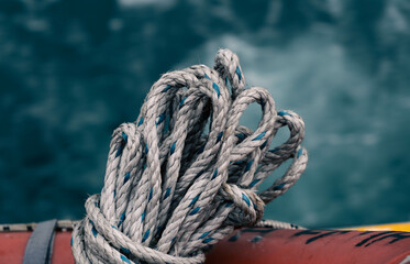 Fototapeta premium a maritime scene with a tranquil sea in the background, while ropes and knots take center stage in the foreground, symbolizing nautical allure and craftsmanship.