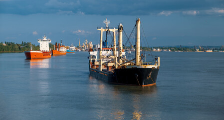 dry-cargo ships stand anchored in the roadstead awaiting loading