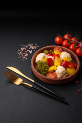 Delicious fresh salad of broccoli, cauliflower, sweet peppers and cherry tomatoes