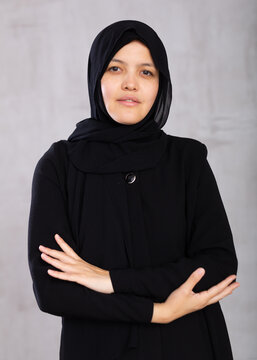 Closeup portrait of young serious woman in hijab posing in studio