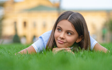 cheerful girl relax at summer lawn. girl relax at summer lawn with grass. girl relax at summer lawn