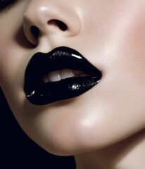 Obraz premium Beautiful and sensual female lips with black lipstick. 