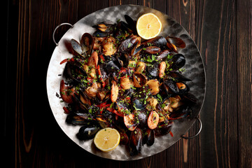 roasted seafood salad with a delectable mix of shrimp, mussels, scallops, and calamari, complemented by vibrant vegetables and flavorful spices