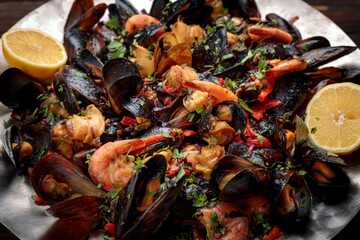 roasted seafood salad with a delectable mix of shrimp, mussels, scallops, and calamari, complemented by vibrant vegetables and flavorful spices