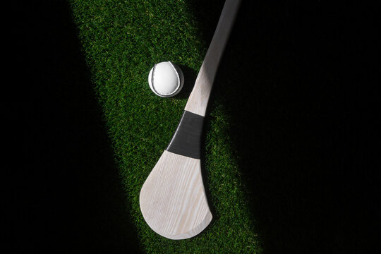 Hurling bat and sloitar on green grass. Horizontal sport theme poster, greeting cards, headers, website and app