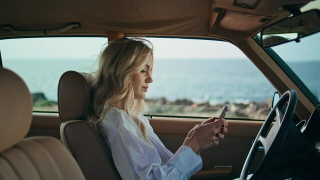 Businesswoman looking phone car standing at beach close up. Girl surfing online.