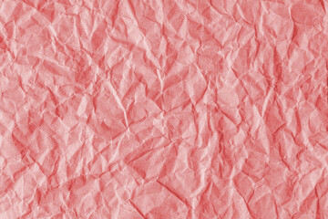 Fototapeta premium Recycled crumpled red paper texture background. Wrinkled and creased abstract backdrop, wallpaper with copy space, top view.