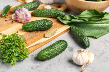Fresh cucumbers for preservation on grunge background