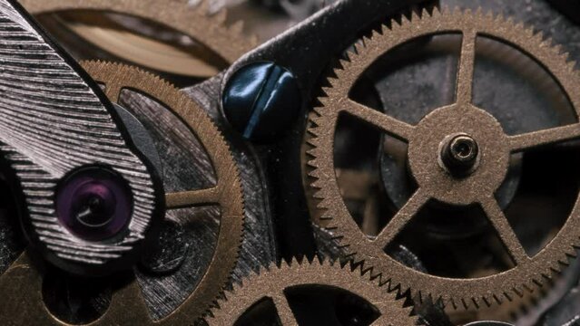 Closeup of turning gears in a mechanical wristwatch - 4K