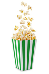 Popcorn flying out of green white striped paper box isolated on white, transparent background, PNG, with copy space. Splash, levitation of popcorn grains.